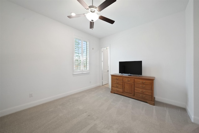 bedroom featuring baseboards, light colored carpet, and ceiling fan