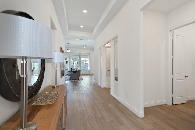 hallway featuring recessed lighting, baseboards, and light wood-type flooring