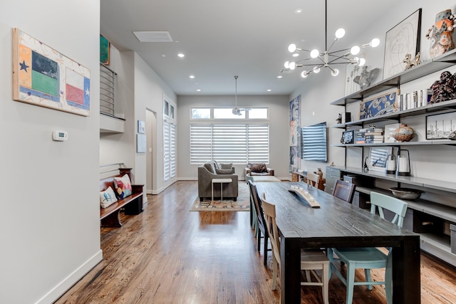 dining room with recessed lighting, baseboards, and wood finished floors