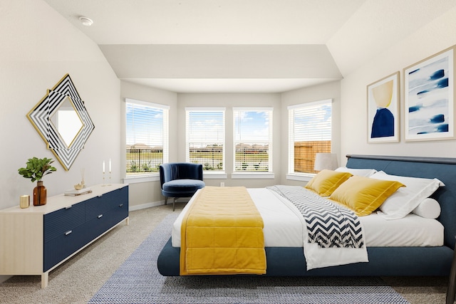 bedroom with baseboards, light carpet, and vaulted ceiling