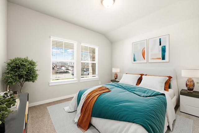 bedroom featuring carpet flooring, baseboards, and vaulted ceiling