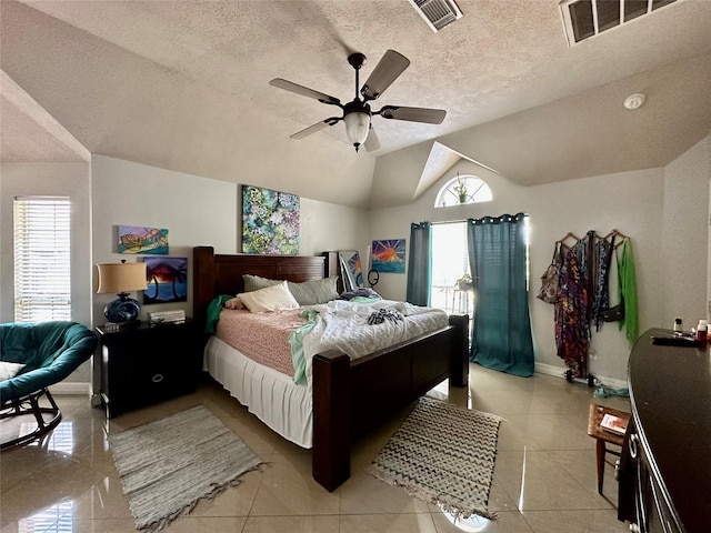 bedroom with visible vents, lofted ceiling, baseboards, and a ceiling fan