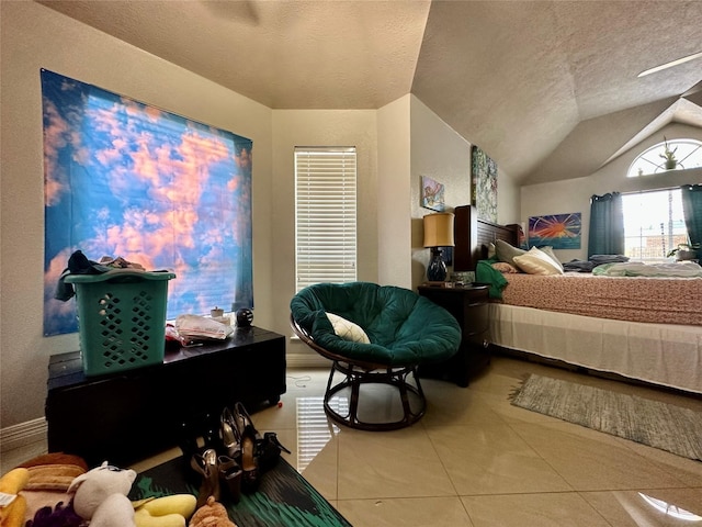 bedroom with tile patterned floors, baseboards, lofted ceiling, and a textured ceiling