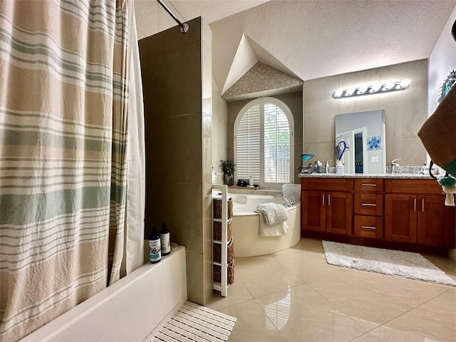 full bathroom with tile patterned flooring, shower / bath combo with shower curtain, double vanity, a textured ceiling, and a sink