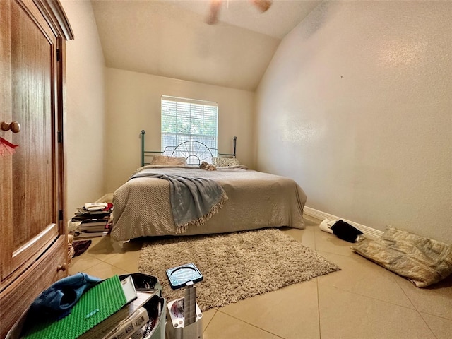 bedroom with tile patterned flooring, lofted ceiling, and baseboards