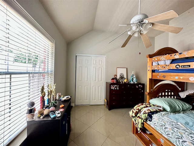 tiled bedroom with lofted ceiling and ceiling fan