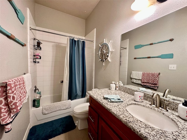 full bath featuring vanity, toilet, shower / bath combo with shower curtain, and a textured wall