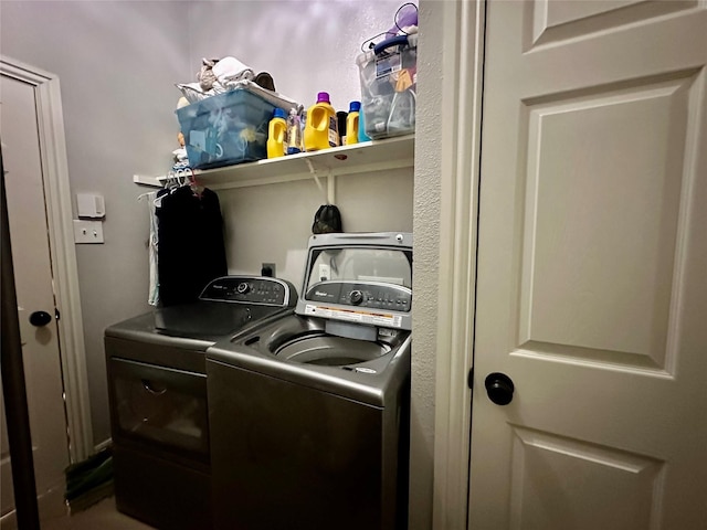 washroom with washing machine and clothes dryer and laundry area