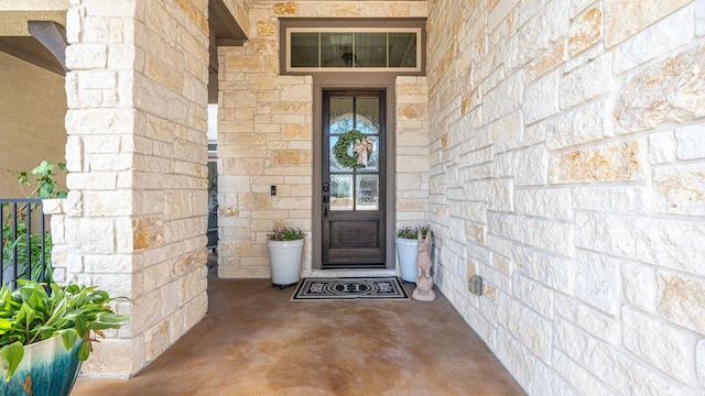 property entrance with stone siding