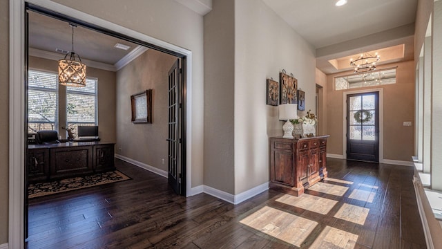 entryway with baseboards, dark wood-type flooring, and an inviting chandelier