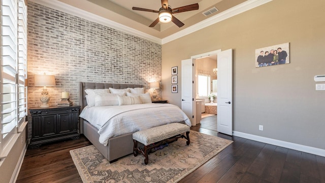 bedroom featuring baseboards, visible vents, dark wood finished floors, crown molding, and a raised ceiling