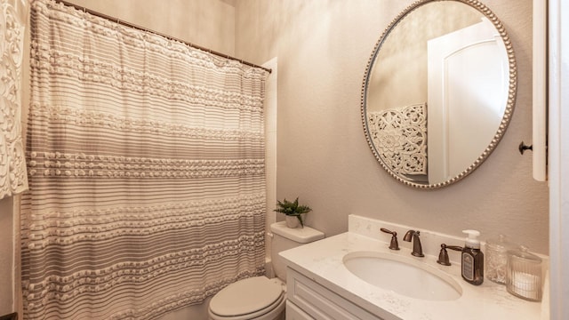 full bathroom with a shower with curtain, toilet, vanity, and a textured wall