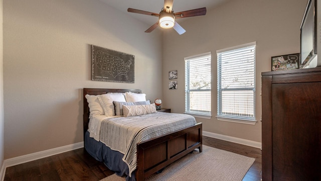 bedroom with ceiling fan, baseboards, and wood finished floors