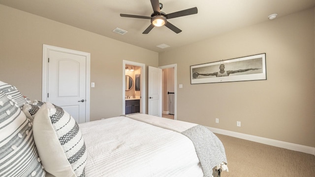 carpeted bedroom featuring baseboards, visible vents, ensuite bathroom, and ceiling fan