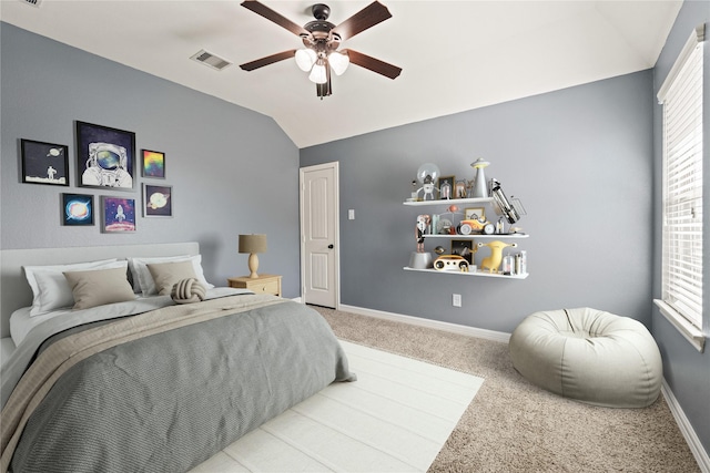 bedroom featuring visible vents, carpet, baseboards, ceiling fan, and vaulted ceiling