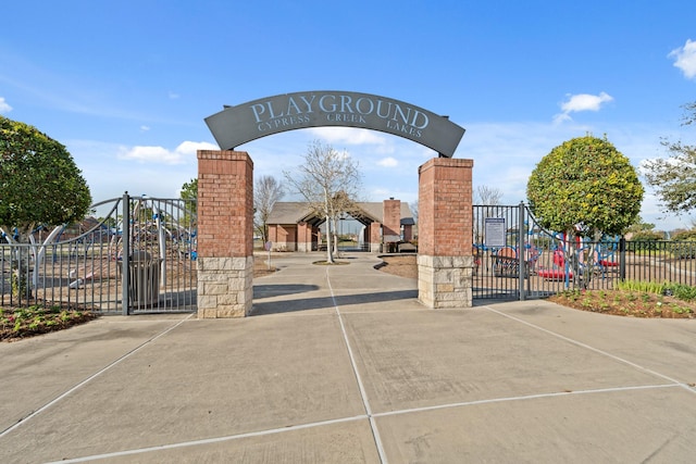 view of property's community with a gate and fence