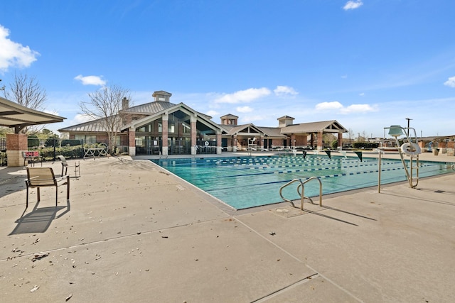 pool featuring a patio and fence