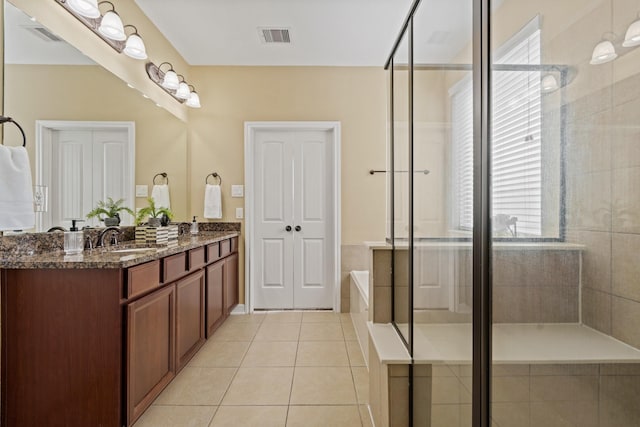 full bath with a garden tub, visible vents, a sink, a shower stall, and tile patterned floors