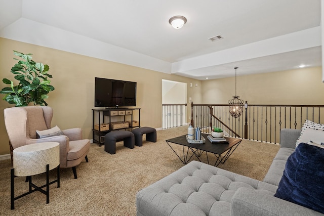 living area with a chandelier, visible vents, baseboards, and carpet floors