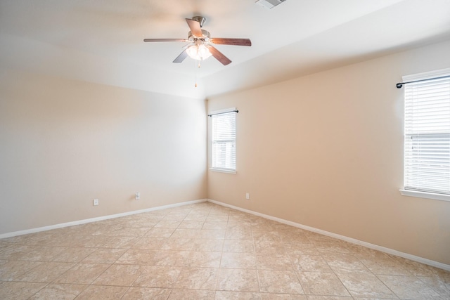 empty room featuring baseboards and a ceiling fan