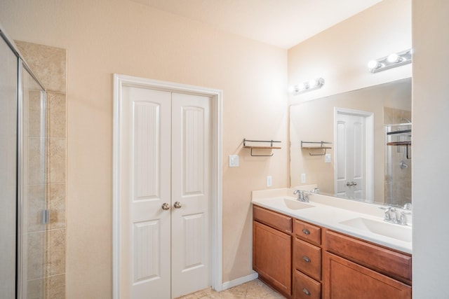 full bathroom with tile patterned flooring, a shower stall, double vanity, and a sink