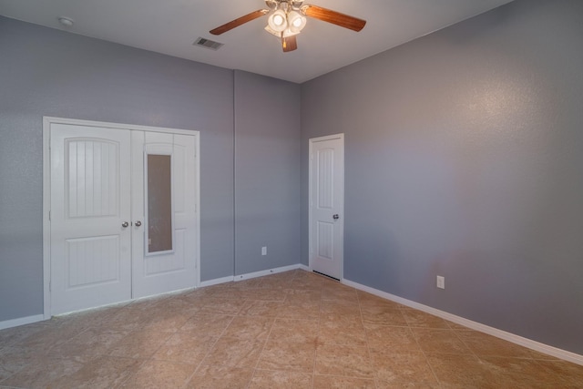 unfurnished bedroom with visible vents, ceiling fan, and baseboards