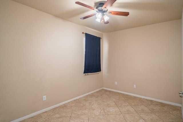 spare room featuring light tile patterned flooring, baseboards, and ceiling fan