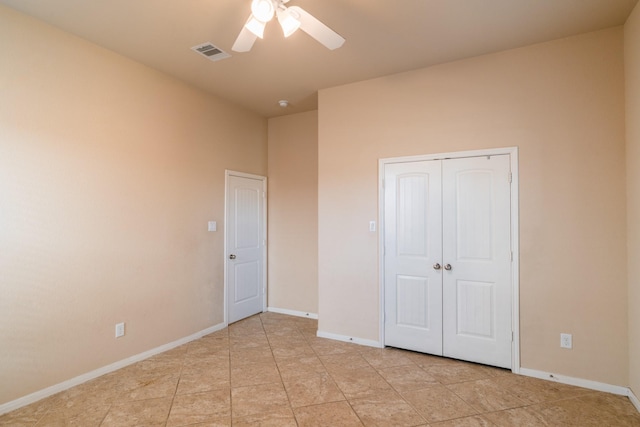 unfurnished bedroom featuring baseboards, visible vents, a closet, and ceiling fan