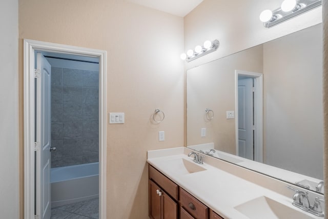 full bathroom featuring a sink, double vanity, and tile patterned flooring