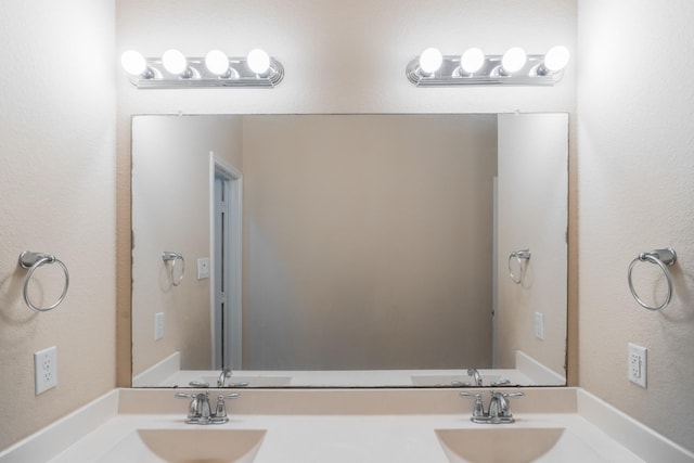 bathroom with a sink and double vanity