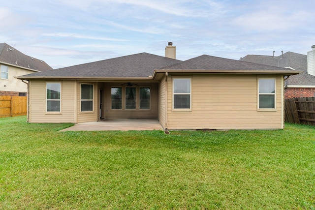 back of property featuring a ceiling fan, a patio area, a yard, and fence