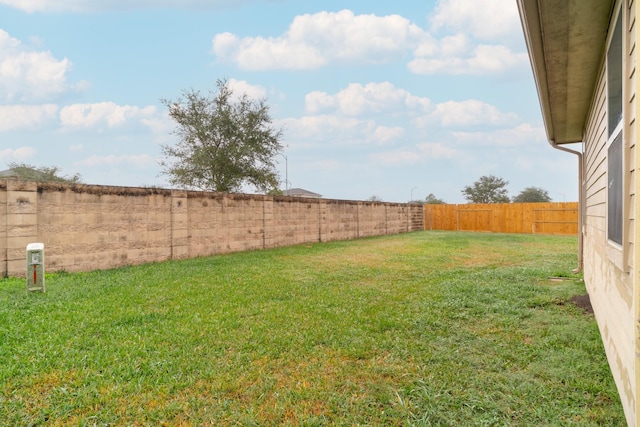 view of yard with a fenced backyard