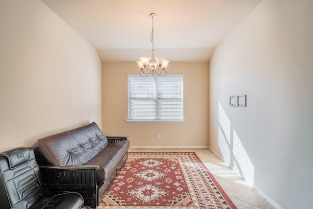 living area with a notable chandelier, baseboards, and vaulted ceiling