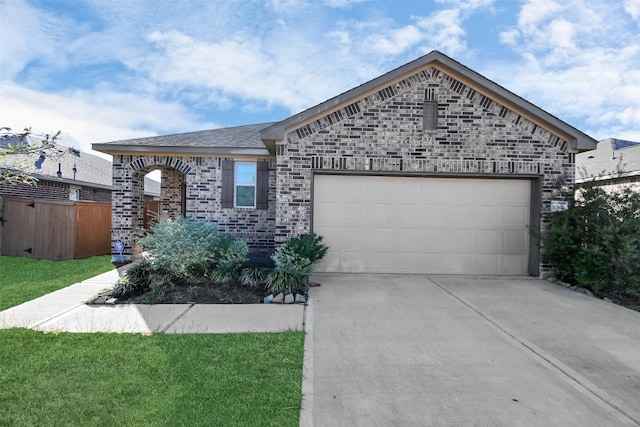 view of front of house featuring brick siding, an attached garage, driveway, and a front yard