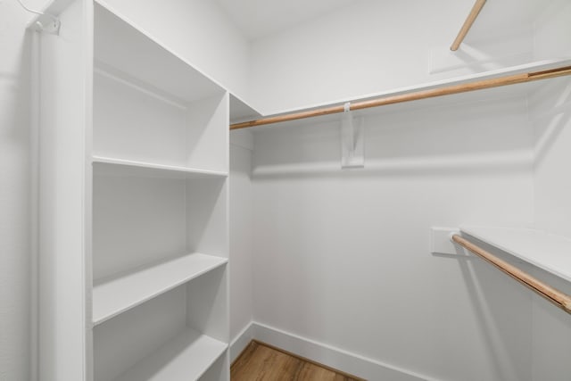 walk in closet featuring wood finished floors