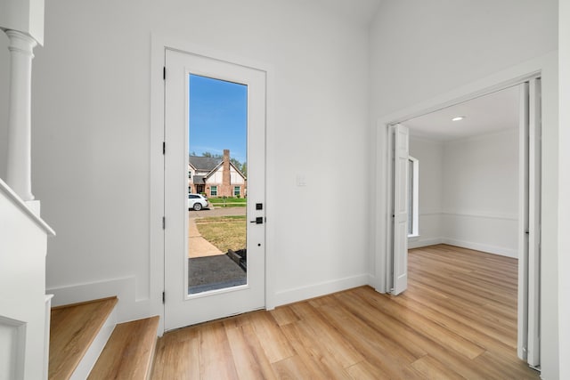 doorway featuring light wood-type flooring and baseboards