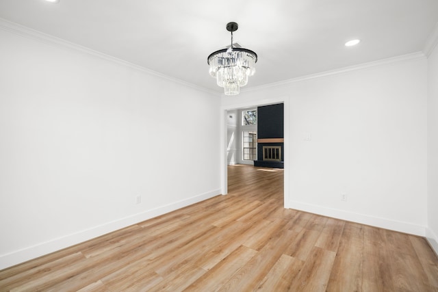 unfurnished dining area with crown molding, baseboards, light wood finished floors, and a chandelier