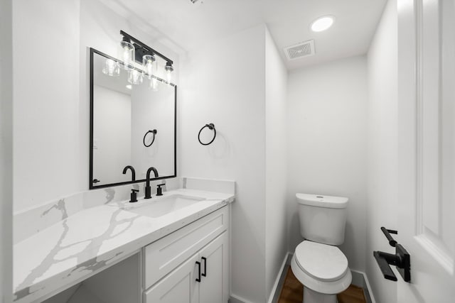 bathroom with visible vents, toilet, recessed lighting, baseboards, and vanity