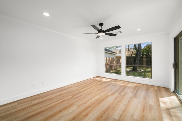 empty room featuring recessed lighting, baseboards, light wood finished floors, and ornamental molding