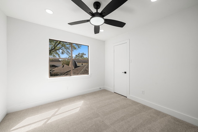 spare room featuring recessed lighting, baseboards, light carpet, and ceiling fan