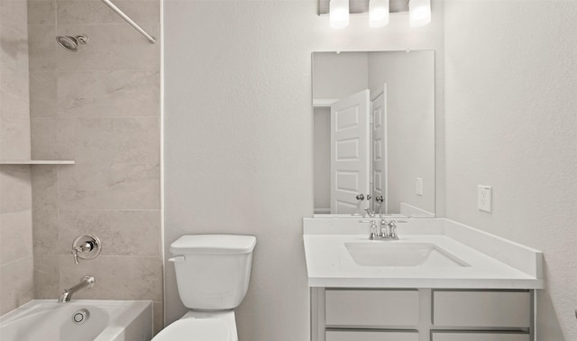 8821 Knoll Branch Dr, Houston, TX 77080 - bathroom featuring toilet, vanity, a textured wall, and washtub / shower combination