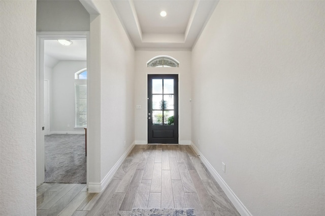 foyer entrance featuring baseboards and light wood finished floors