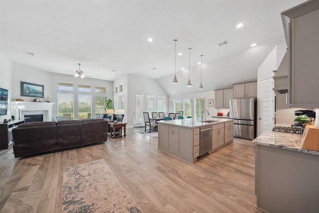 kitchen with visible vents, gray cabinets, appliances with stainless steel finishes, and a sink