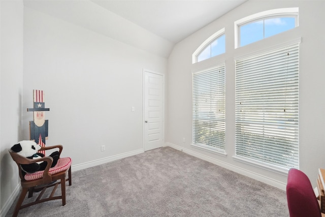 sitting room featuring a wealth of natural light, baseboards, carpet floors, and lofted ceiling