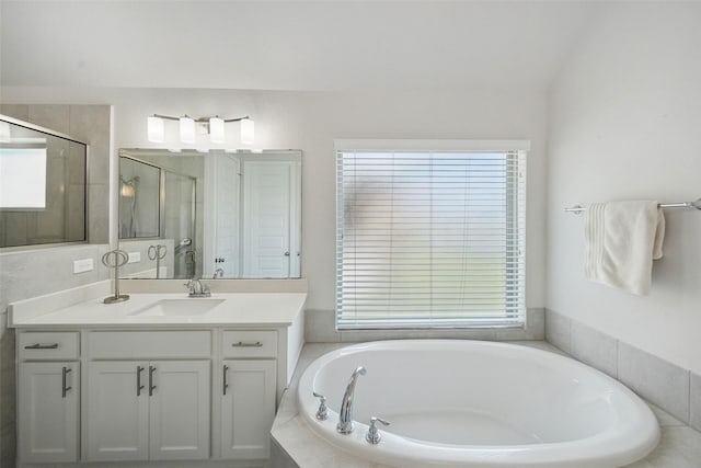 bathroom with vanity, a shower stall, and a bath