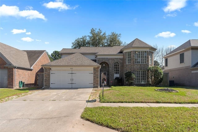 view of front facade featuring concrete driveway, a front lawn, an attached garage, and a shingled roof