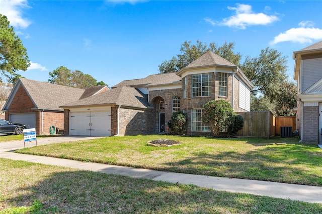 view of front of house featuring brick siding, a front lawn, central air condition unit, a garage, and driveway