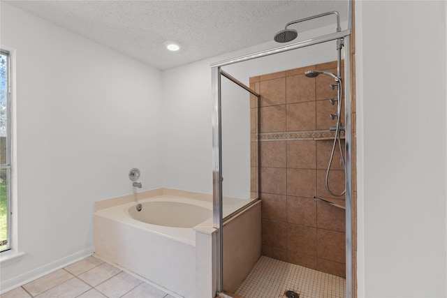 bathroom with a stall shower, tile patterned flooring, a bath, and a healthy amount of sunlight