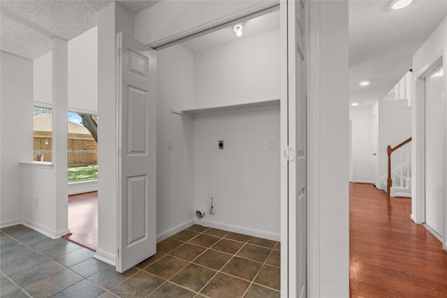 laundry room with recessed lighting, dark tile patterned flooring, laundry area, electric dryer hookup, and a textured ceiling