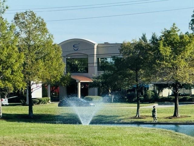 view of property's community with a yard